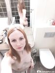 Skinny redhead girl posing in her bathroom naked